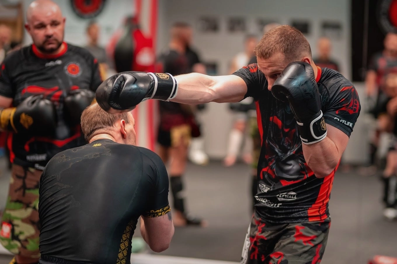 Zdjęcie przedstawiające dwie osoby podczas treningu bokserskiego w Rzeszowie.